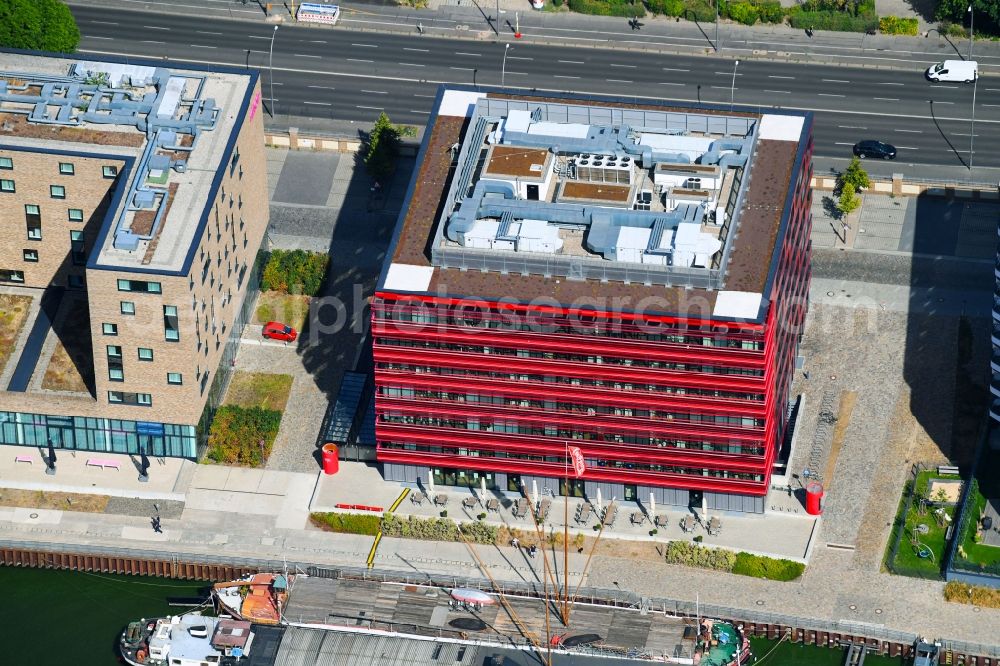 Aerial photograph Berlin - Coca-Cola- House on Stralauer Allee and the riverbank of the Spree in the Friedrichshain part of Berlin in Germany. The red building is part of a series of new buildings on the river