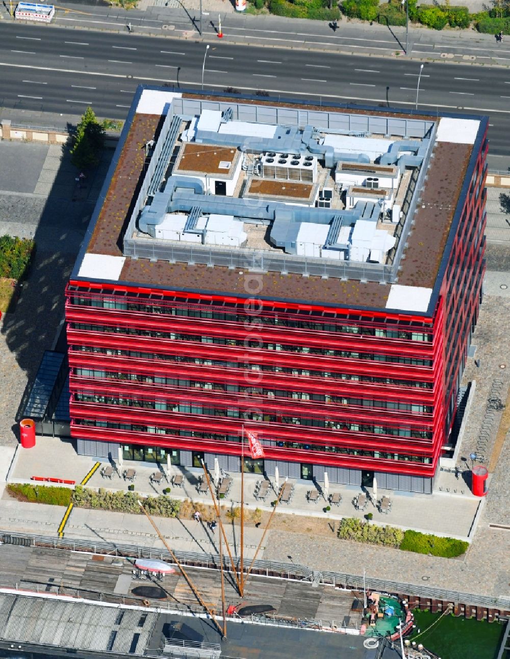 Berlin from above - Coca-Cola- House on Stralauer Allee and the riverbank of the Spree in the Friedrichshain part of Berlin in Germany. The red building is part of a series of new buildings on the river