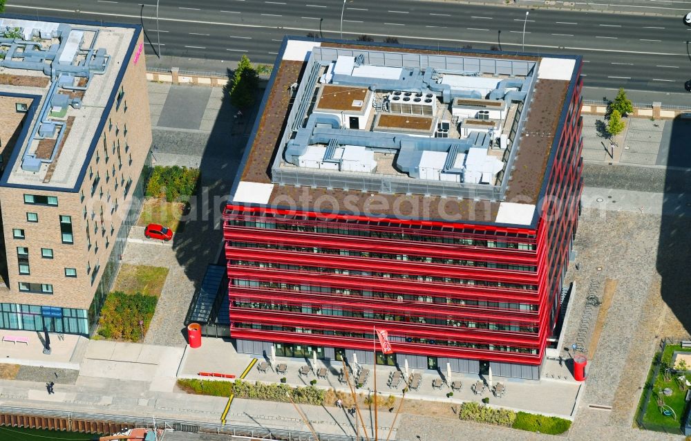 Berlin from the bird's eye view: Coca-Cola- House on Stralauer Allee and the riverbank of the Spree in the Friedrichshain part of Berlin in Germany. The red building is part of a series of new buildings on the river