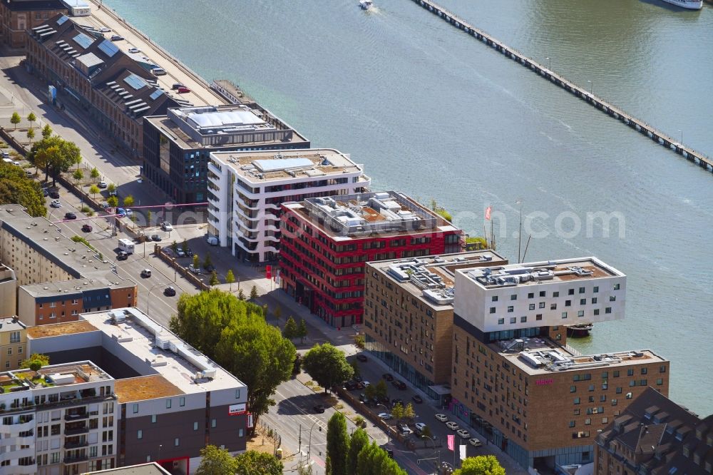 Aerial image Berlin - Coca-Cola- House on Stralauer Allee and the riverbank of the Spree in the Friedrichshain part of Berlin in Germany. The red building is part of a series of new buildings on the river