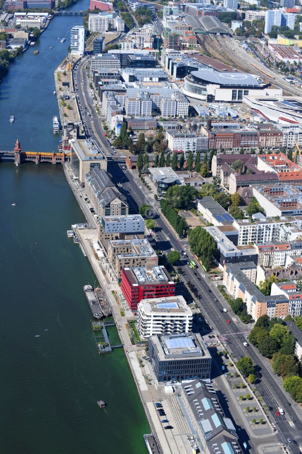 Berlin from above - Coca-Cola- House on Stralauer Allee and the riverbank of the Spree in the Friedrichshain part of Berlin in Germany. The red building is part of a series of new buildings on the river