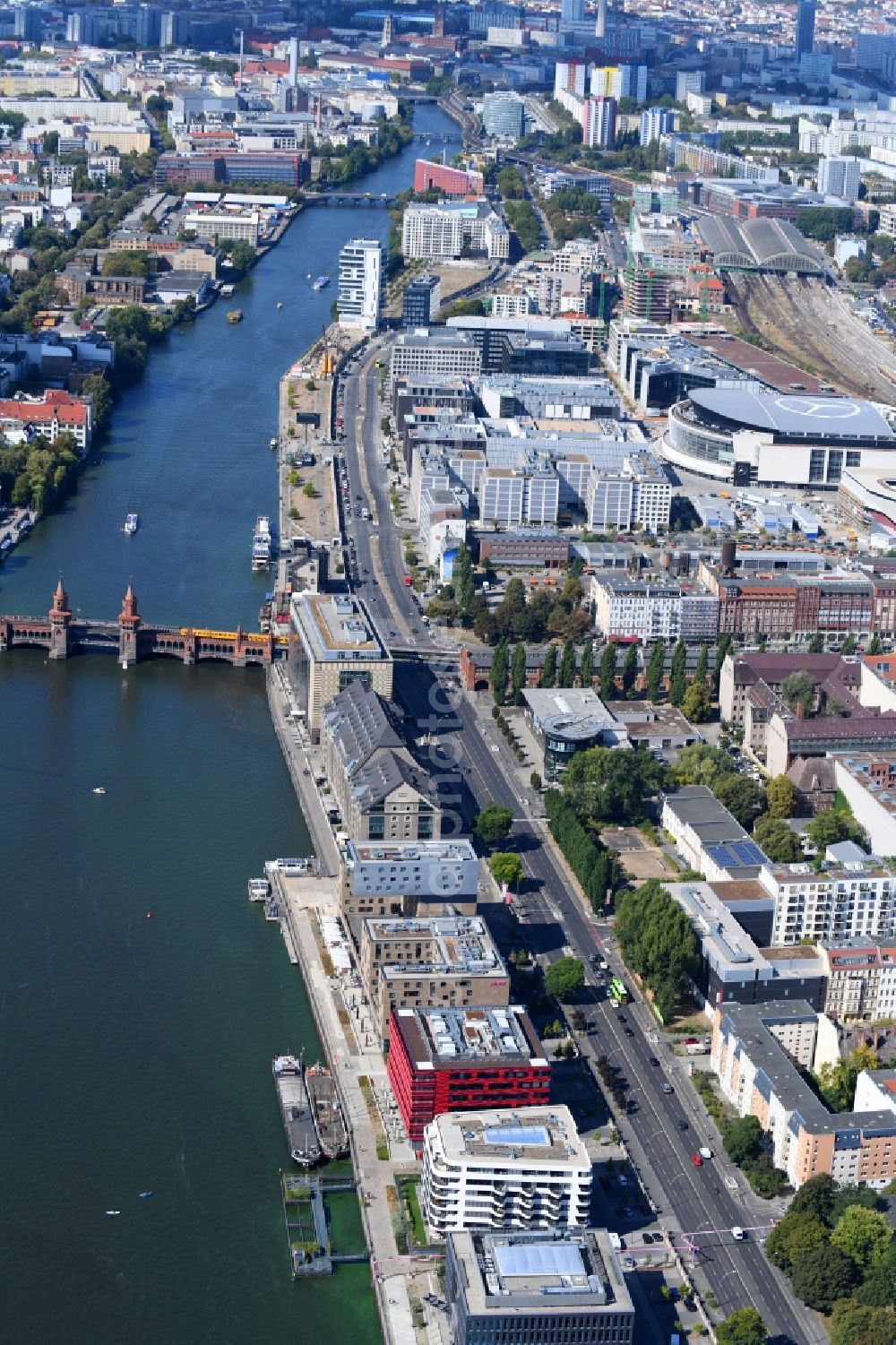 Berlin from the bird's eye view: Coca-Cola- House on Stralauer Allee and the riverbank of the Spree in the Friedrichshain part of Berlin in Germany. The red building is part of a series of new buildings on the river