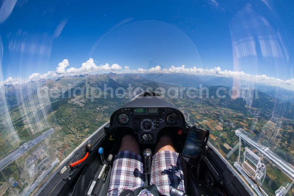 Châteauroux-les-Alpes from above - Cockpit view from the glider Mosquito over mountains of the Alps and cumulus clouds at Chateauroux-les-Alpes in Provence-Alpes-Cote d'Azur, France