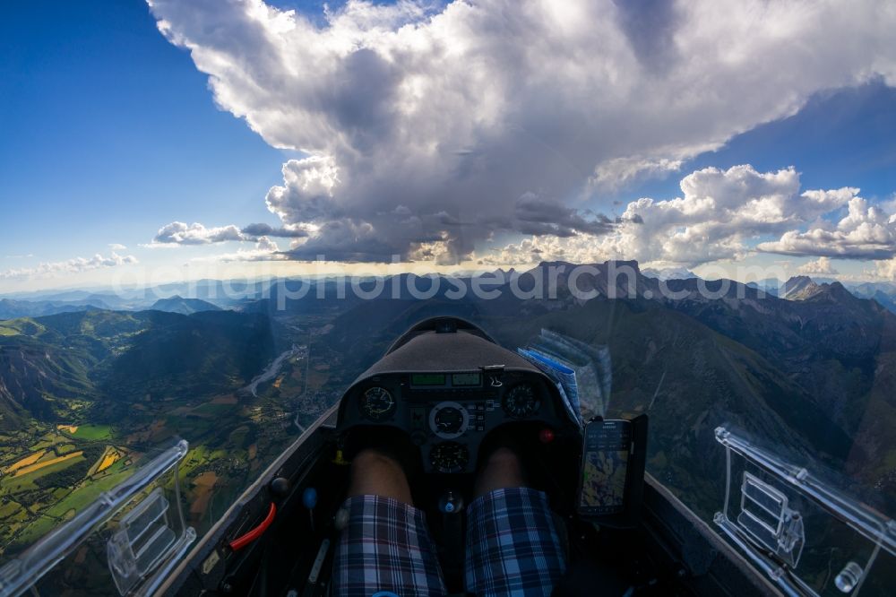 Aerial image La Roche-des-Arnauds - Cockpit view from the glider Mosquito over the mountain peaks of Pic de bure and a thundercloud at La Roche-des-Arnauds in Provence-Alpes-Cote d'Azur, France