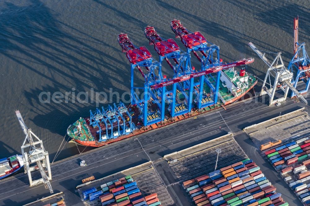 Hamburg from the bird's eye view: Container Terminal Burchardkai Unlanding of 3 container cranes from a transport ship in Hamburg, Germany