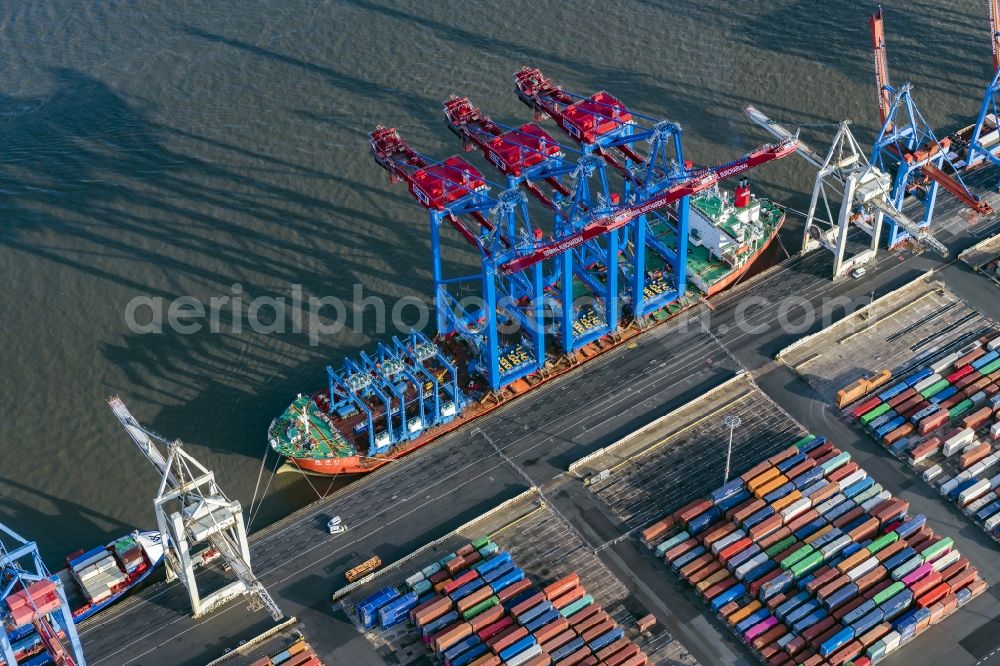 Aerial photograph Hamburg - Container Terminal Burchardkai Unlanding of 3 container cranes from a transport ship in Hamburg, Germany