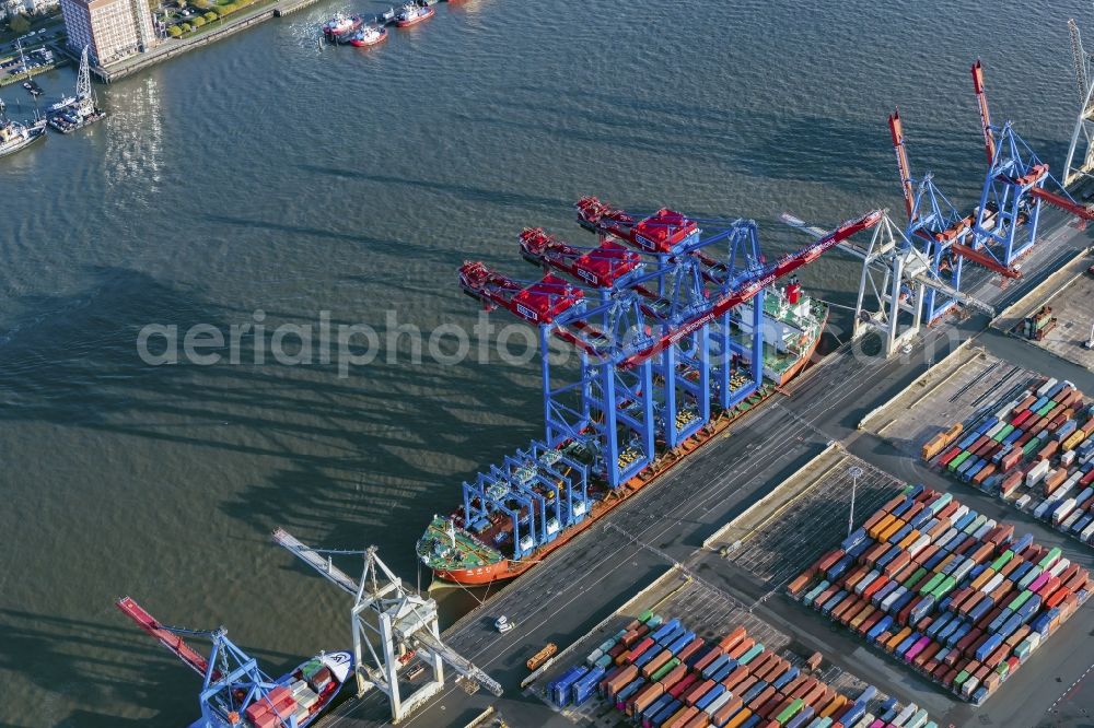 Hamburg from above - Container Terminal Burchardkai Unlanding of 3 container cranes from a transport ship in Hamburg, Germany