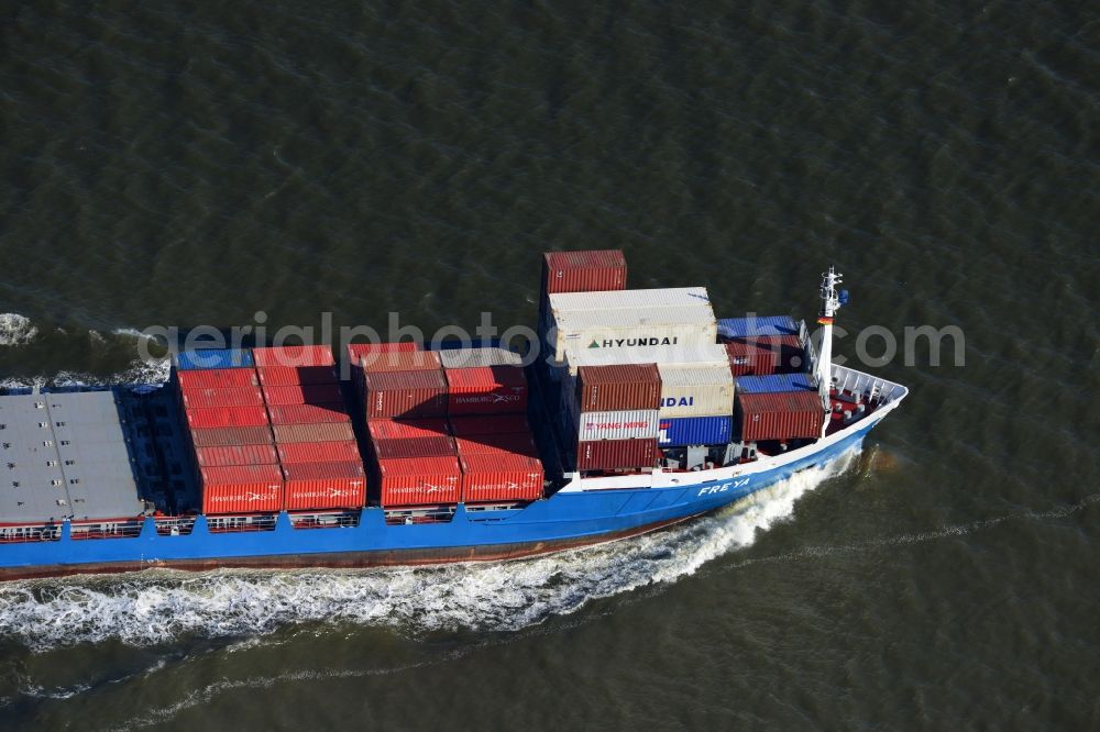 Cuxhaven from the bird's eye view: Container ship - FREYA a Dutch freighter cruise in the bay of the North Sea coast near Cuxhaven in Lower Saxony