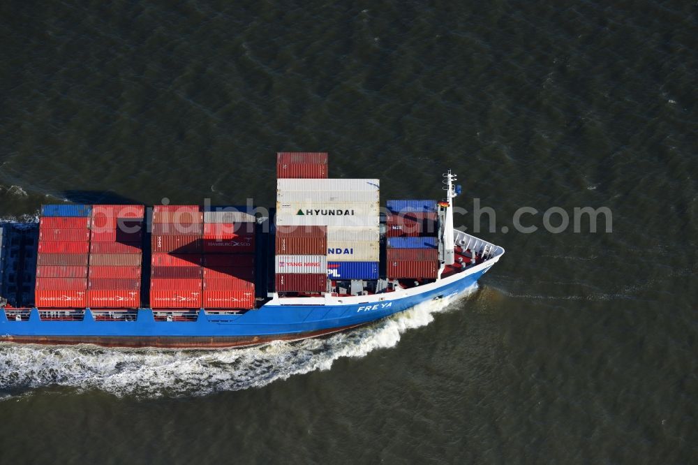 Aerial image Cuxhaven - Container ship - FREYA a Dutch freighter cruise in the bay of the North Sea coast near Cuxhaven in Lower Saxony