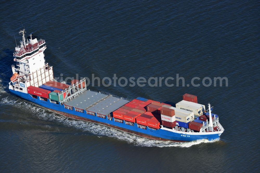 Cuxhaven from the bird's eye view: Container ship - FREYA a Dutch freighter cruise in the bay of the North Sea coast near Cuxhaven in Lower Saxony