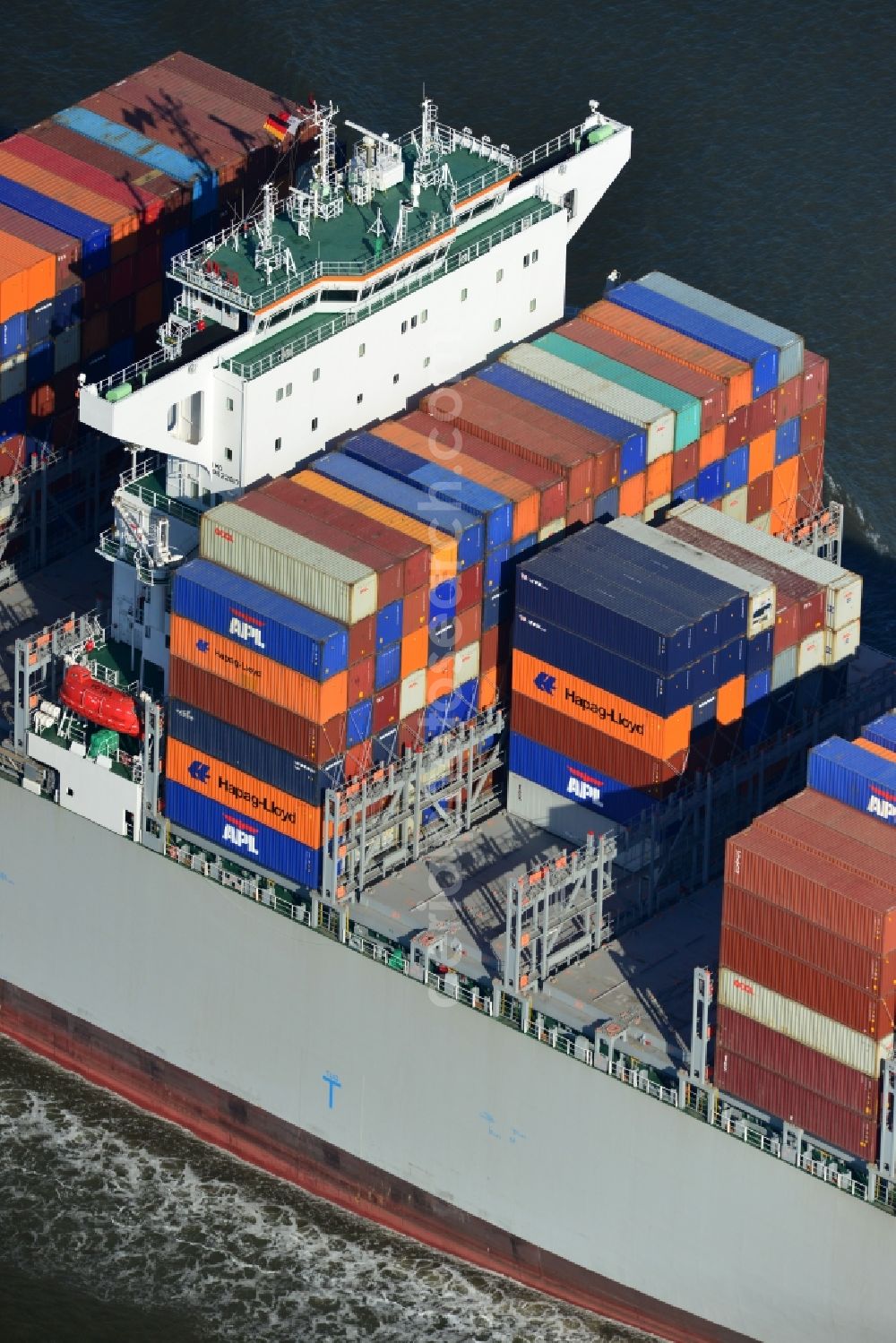 Cuxhaven from above - Container ship - the cargo shipping company NYK Line NYK Hercules GmbH in driving off the North Sea coast near Cuxhaven in Lower Saxony