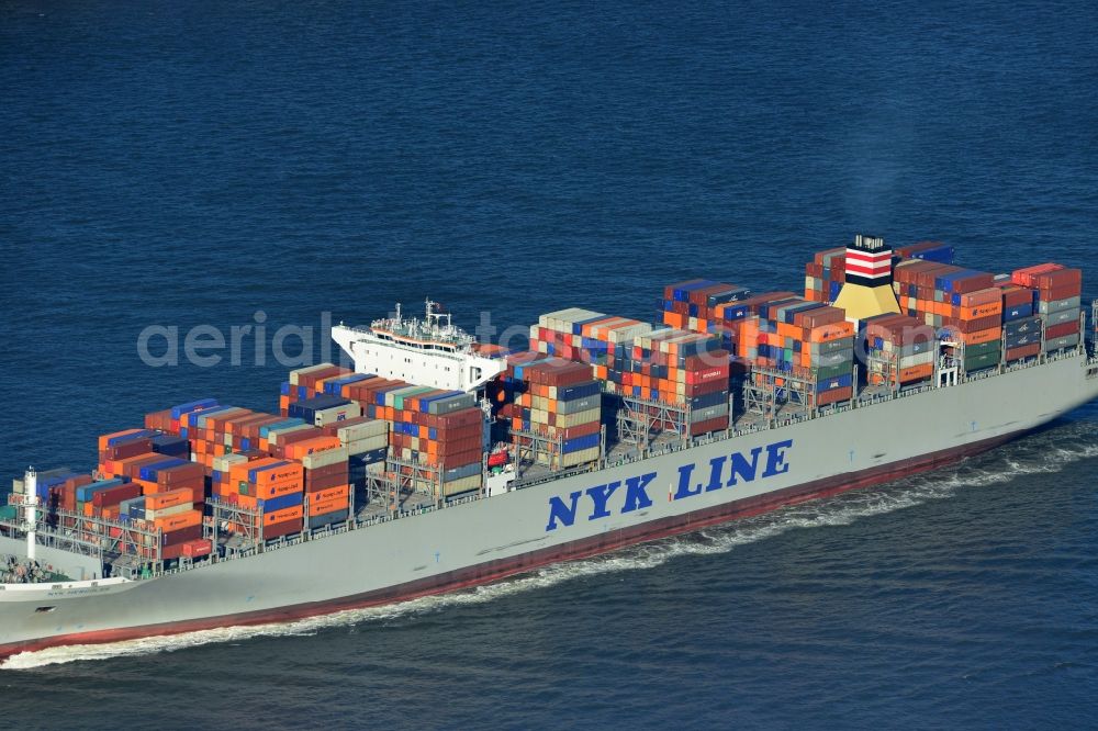 Aerial image Cuxhaven - Container ship - the cargo shipping company NYK Line NYK Hercules GmbH in driving off the North Sea coast near Cuxhaven in Lower Saxony