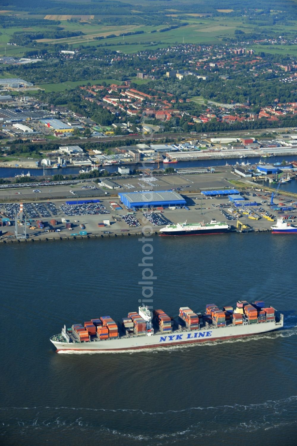 Cuxhaven from above - Container ship - the cargo shipping company NYK Line NYK Hercules GmbH in driving off the North Sea coast near Cuxhaven in Lower Saxony