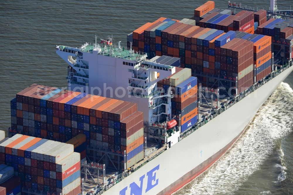 Cuxhaven from above - Container ship - the cargo shipping company NYK Line NYK Hercules GmbH in driving off the North Sea coast near Cuxhaven in Lower Saxony