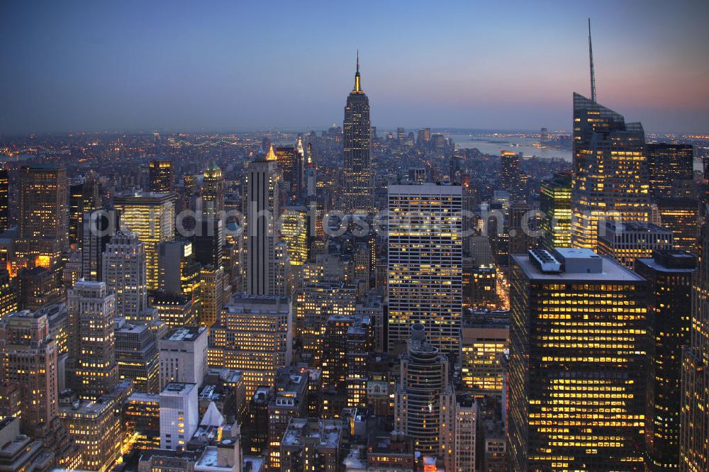 Aerial image New York - View of the Midtown centre of New York's borough of Manhattan with the illuminated skyscrapers of the financial district, including the Empire State Building and the Bank of America Tower