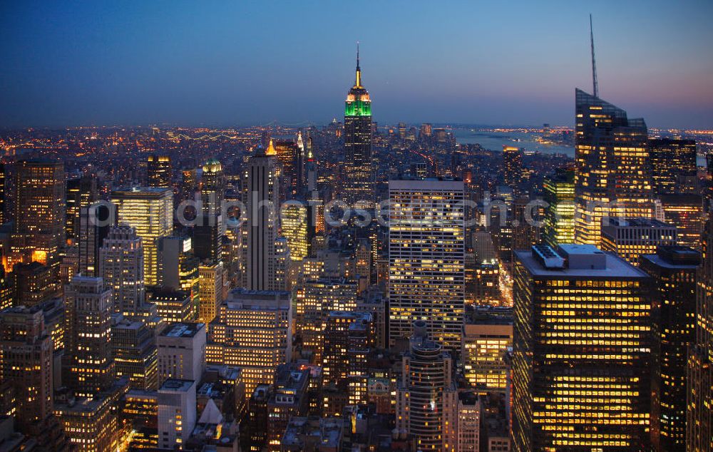 Aerial image New York - View of the Midtown centre of New York's borough of Manhattan with the illuminated skyscrapers of the financial district, including the Empire State Building and the Bank of America Tower