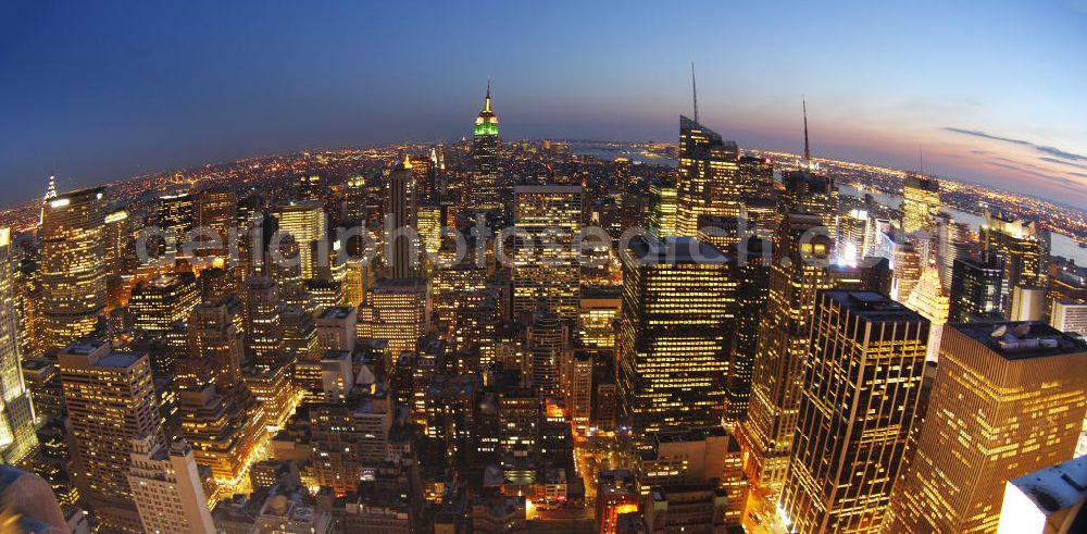 Aerial photograph New York - View of the Midtown centre of New York's borough of Manhattan with the illuminated skyscrapers of the financial district, including the Empire State Building and the Bank of America Tower