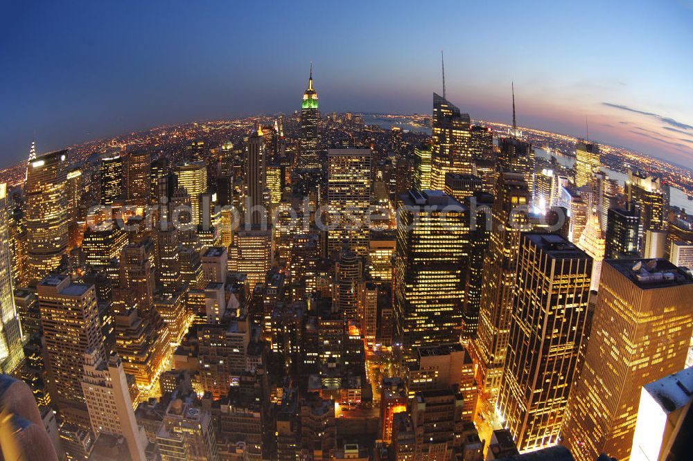 New York from above - View of the Midtown centre of New York's borough of Manhattan with the illuminated skyscrapers of the financial district, including the Empire State Building and the Bank of America Tower