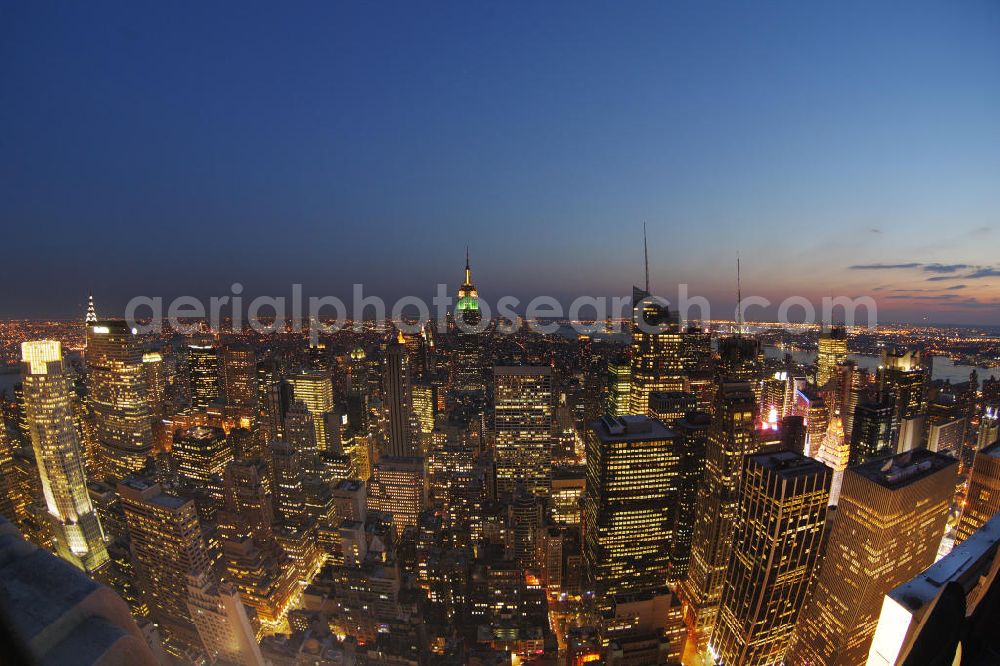 New York from the bird's eye view: View of the Midtown centre of New York's borough of Manhattan with the illuminated skyscrapers of the financial district, including the Empire State Building and the Bank of America Tower