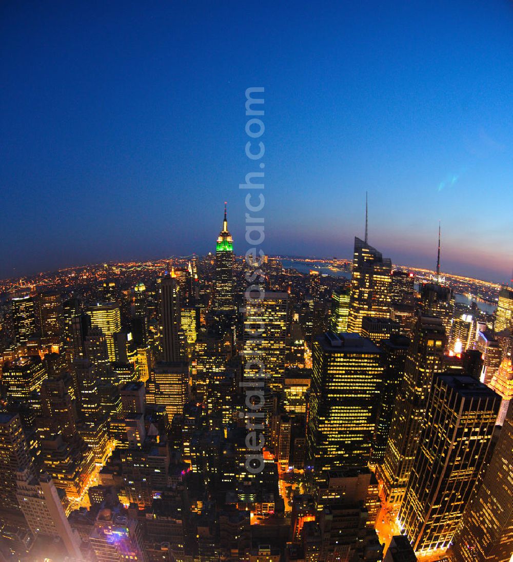 Aerial image New York - View of the Midtown centre of New York's borough of Manhattan with the illuminated skyscrapers of the financial district, including the Empire State Building and the Bank of America Tower