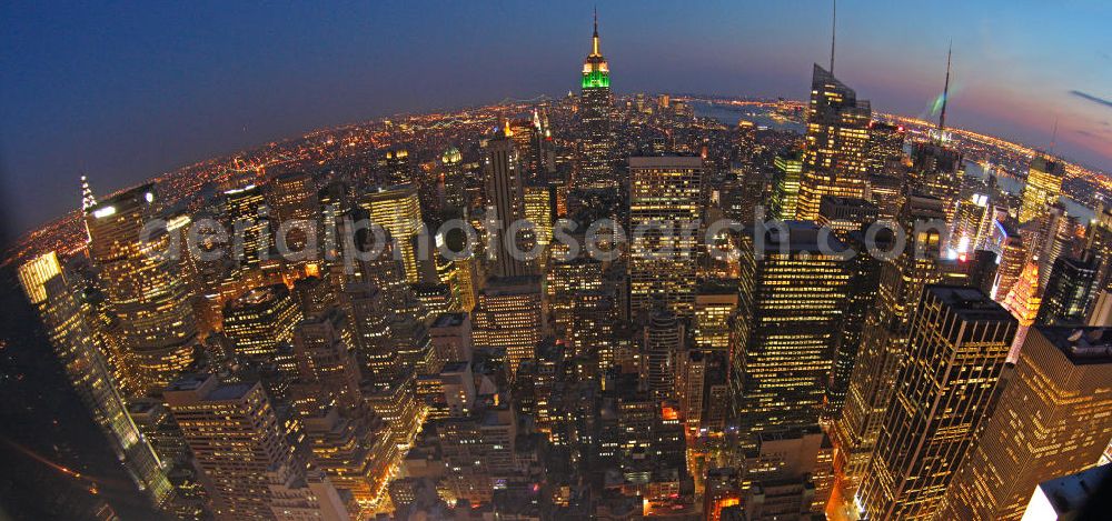 Aerial photograph New York - View of the Midtown centre of New York's borough of Manhattan with the illuminated skyscrapers of the financial district, including the Empire State Building and the Bank of America Tower