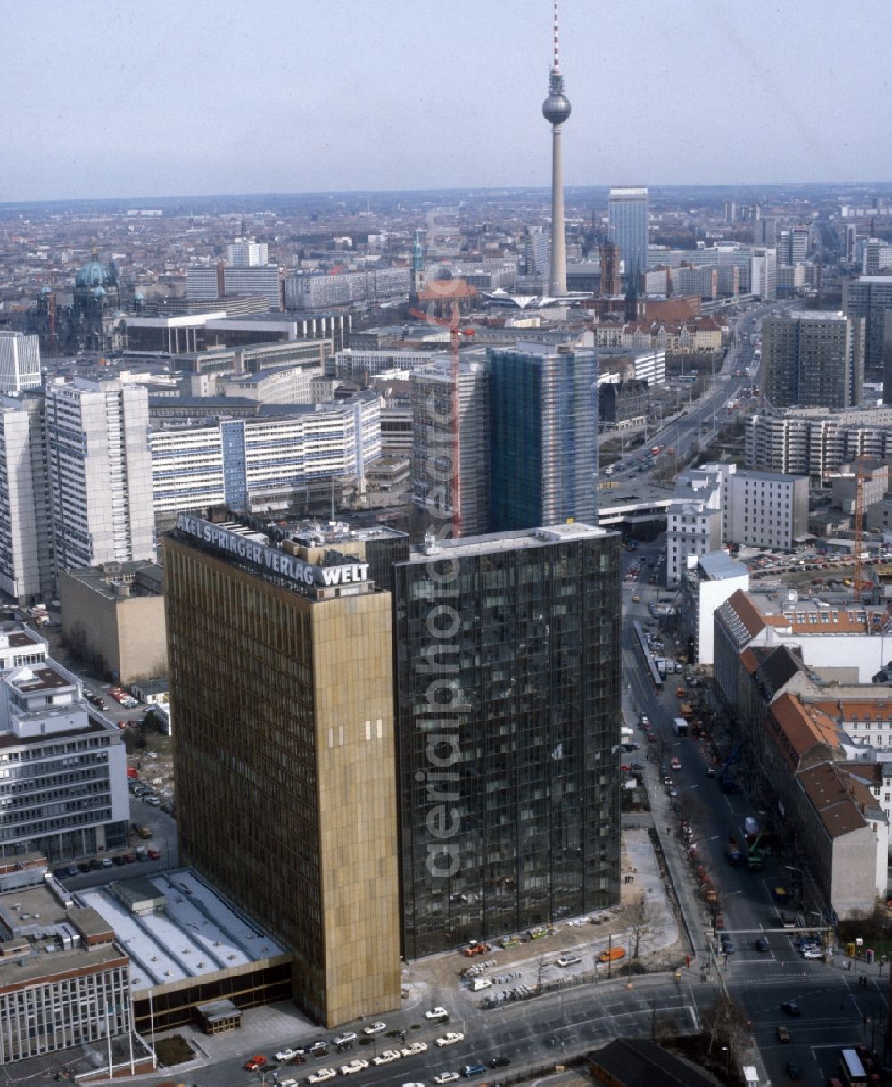 Aerial image Berlin - The Axel Springer house in the center of Berlin in the state of Berlin. The Axel-Springer-Verlag is a high-rise building and is part of the media group Axel Springer AG. It is located at the intersection of Rudi Dutschke street with Axel-Springer-road. In the background the Berlin TV Tower and the Red City Hall can be seen