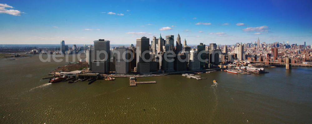 New York from the bird's eye view: View of the island and the district of Manhattan in New York from the harbor side. The skyscrapers and ferry terminals are located in the Financial District of the borough