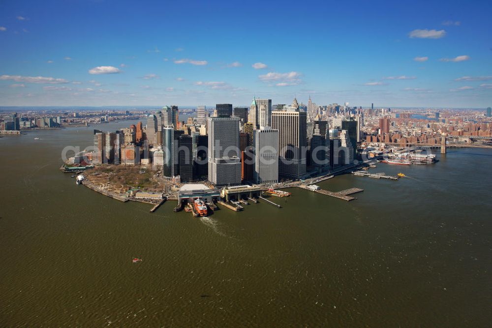 Aerial image New York - View of the island and the district of Manhattan in New York from the harbor side. The skyscrapers and ferry terminals are located in the Financial District of the borough