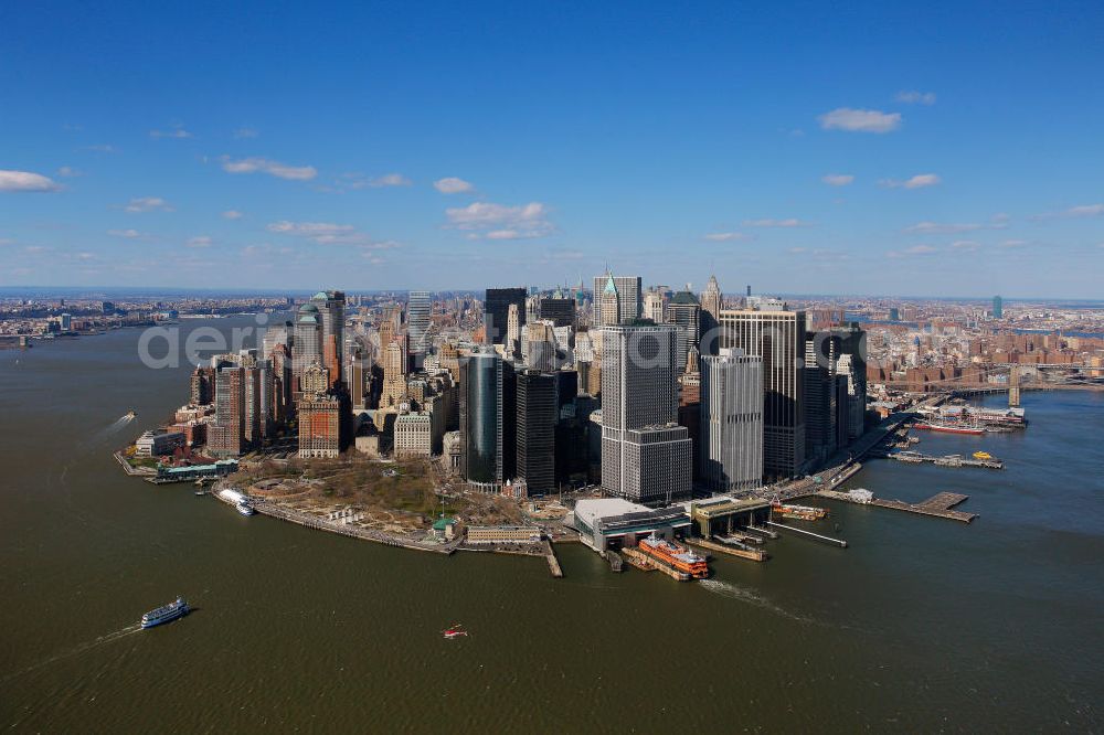 Aerial photograph New York - View of the island and the district of Manhattan in New York from the harbor side. The skyscrapers and ferry terminals are located in the Financial District of the borough