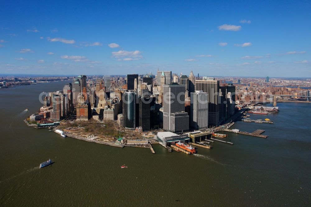 New York from above - View of the island and the district of Manhattan in New York from the harbor side. The skyscrapers and ferry terminals are located in the Financial District of the borough