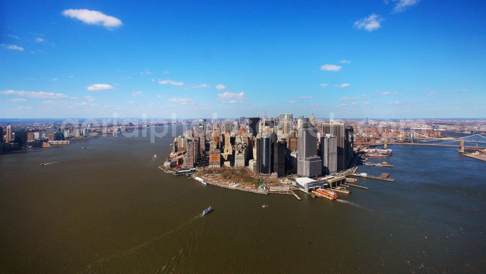 New York from the bird's eye view: View of the island and the district of Manhattan in New York from the harbor side. The skyscrapers and ferry terminals are located in the Financial District of the borough