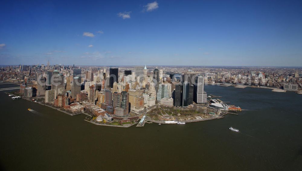 Aerial image New York - View of the island and the district of Manhattan in New York from the harbor side. The skyscrapers and ferry terminals are located in the Financial District of the borough