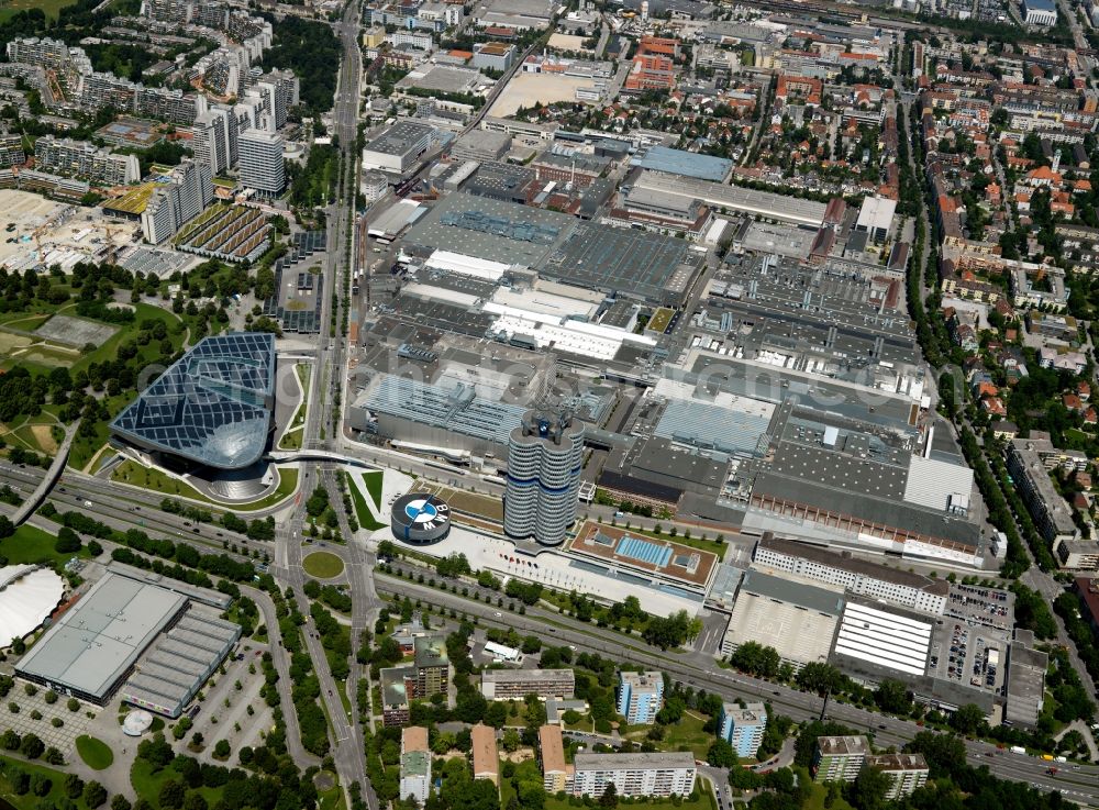 Aerial photograph München - The BMW-factory Munich in the Milbertshofen part of Munich in the state of Bavaria. The parent plant of the car company has been located here since the 1960s amidst a residential area. It is the production site of motors and the BMW 3 series of cars. The facilities also include the headquarters BMW Fourcylinder, an office tower. Next to it, there is the round BMW Museum with the company's logo on top and the BMW World