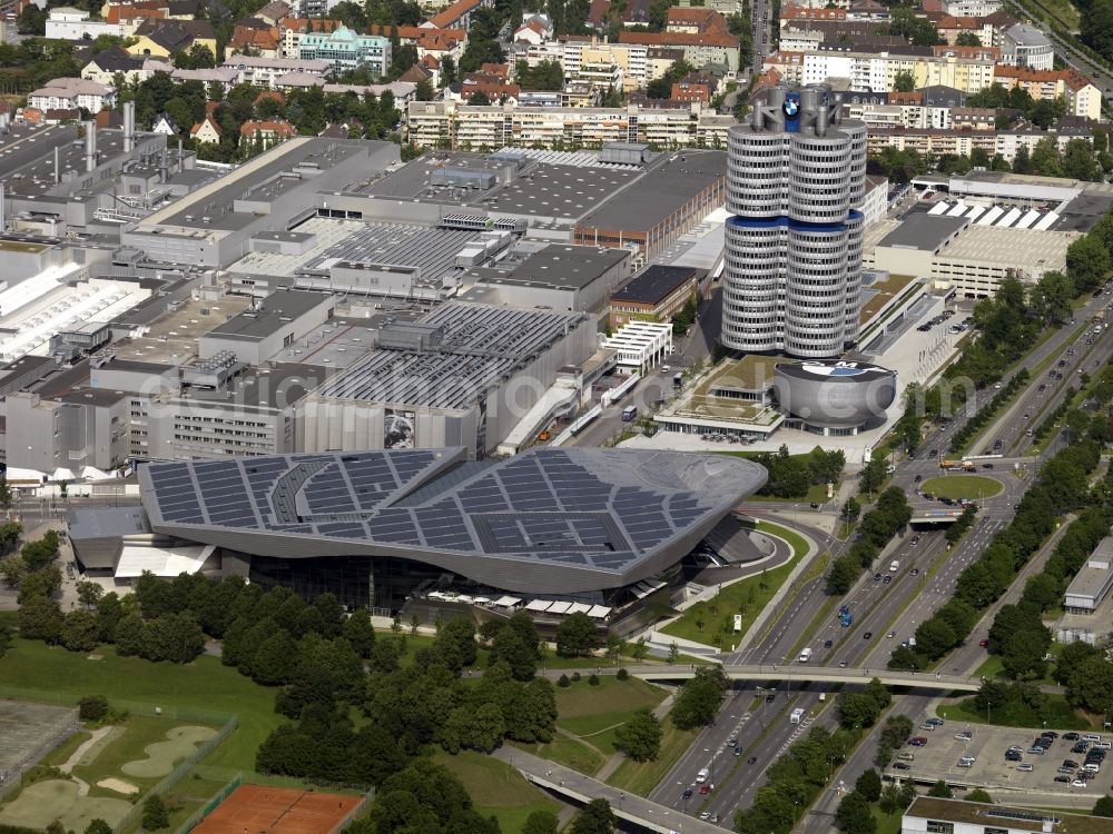 Aerial image München - The BMW-factory Munich in the Milbertshofen part of Munich in the state of Bavaria. The parent plant of the car company has been located here since the 1960s amidst a residential area. It is the production site of motors and the BMW 3 series of cars. The facilities also include the headquarters BMW Fourcylinder, an office tower. Next to it, there is the round BMW Museum with the company's logo on top and the BMW World