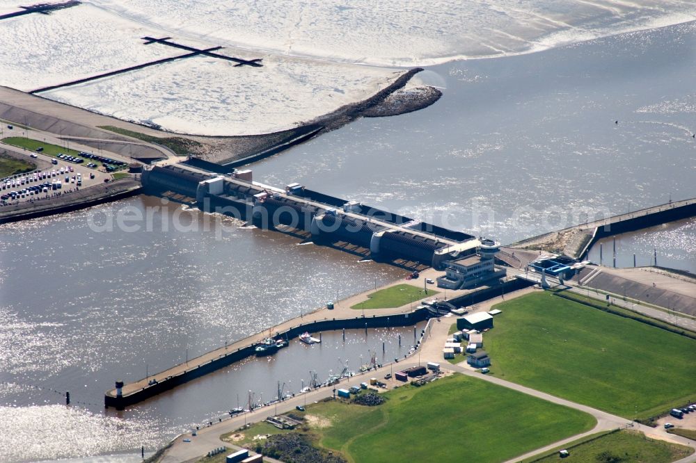 Tönning from the bird's eye view: The Eider flood barrier in Toenning in the state of Schleswig-Holstein. The barrage is located on the mouth of the river Eider, going into the North Sea. The barrier is in place for protection against storm flooding of the North Sea. It was built in 1967, consisting of 2 rows with 5 gates each to provide double flooding protection