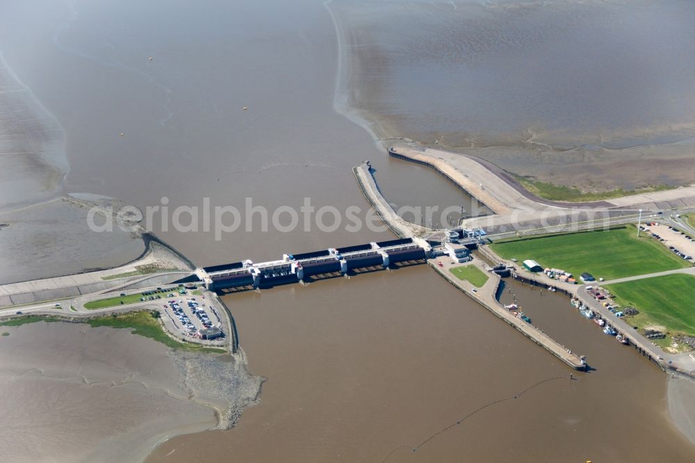 Tönning from above - The Eider flood barrier in Toenning in the state of Schleswig-Holstein. The barrage is located on the mouth of the river Eider, going into the North Sea. The barrier is in place for protection against storm flooding of the North Sea. It was built in 1967, consisting of 2 rows with 5 gates each to provide double flooding protection