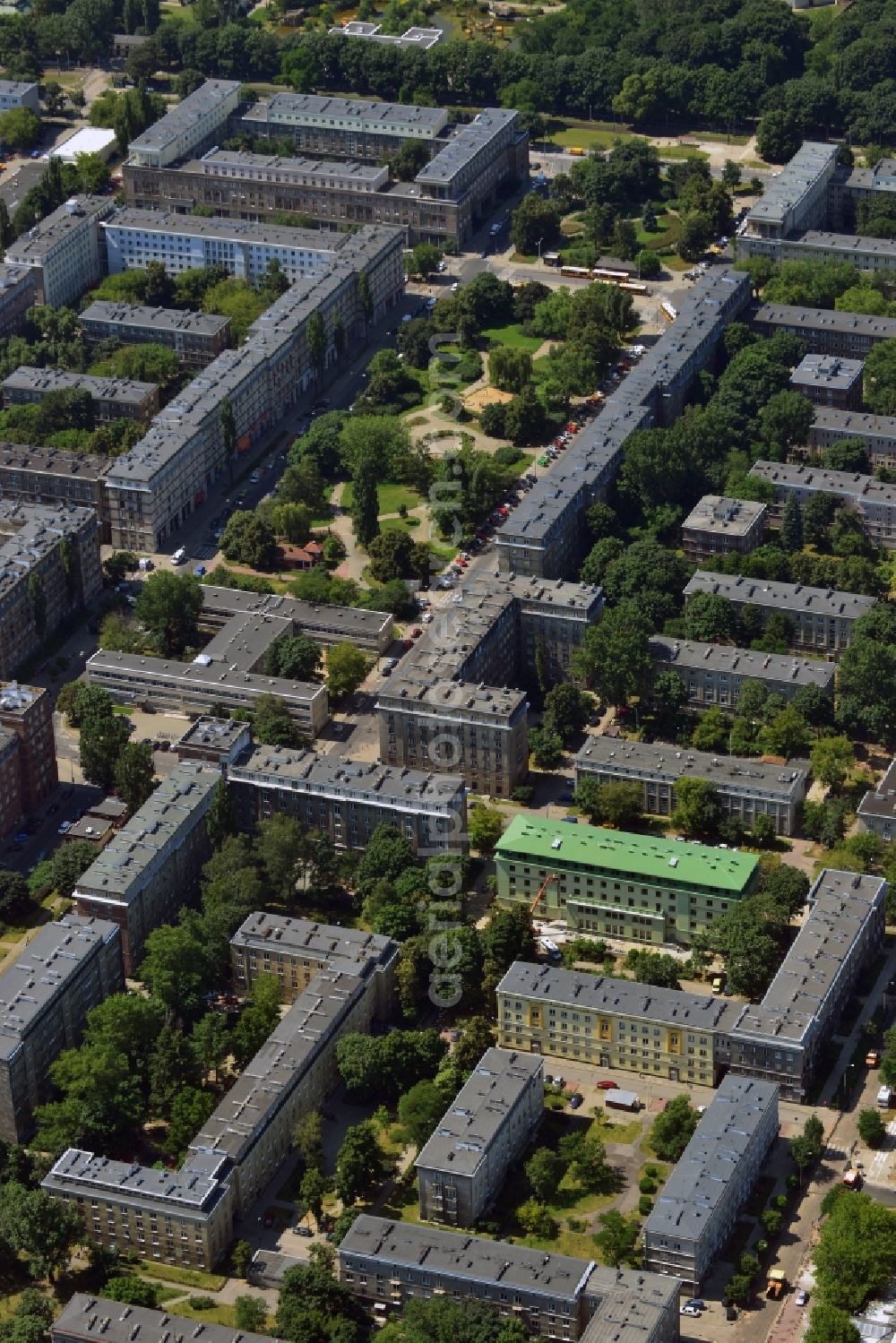 Warschau from above - The revenue office of the borough of Targowek in Warsaw in Poland. The distinct historic building with its green roof is located amidst a residential area and estate near the park Placu Hallera which is further to the West. Visible here are the well trimmed lawns and trees of the public green