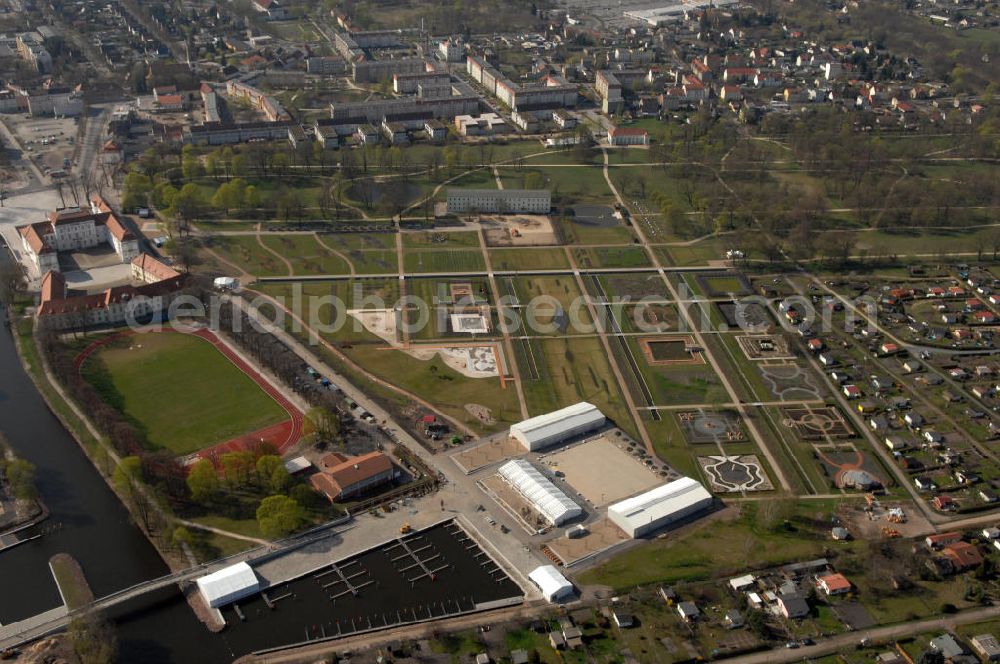 ORANIENBURG from the bird's eye view: Blick auf das Schloss Oranienburg mit dem Gelände der Landesgartenschau. Das Schloss Oranienburg ist das älteste Barockschloss in der Mark Brandenburg. Bis 1999 wurde das Gebäude umfassend saniert und restauriert. Als bedeutsam erachtete historische Räume konnten wiederhergestellt werden, u.a. der Orange Saal. Das Schloss wird seitdem von der Stadtverwaltung genutzt und beherbergt das Schlossmuseum, getragen von der Stiftung preußischer Schlösser und Gärten und dem Kreismuseum Oranienburg. Oranienburg richtet unter dem Motto „Traumlandschaften einer Kurfürstin“ die brandenburgische Landesgartenschau 2009 aus. Geöffnet ist die Landesgartenschau vom 25. April bis zum 18. Oktober 2009. Kontakt: Schlossmuseum Oranienburg: Jörg Kirschstein, Abteilung Schlossmanagement, Schlossbereichsleiter, Schlossplatz 1, 16515 Oranienburg, Tel. +49 (0)3301 53 74 37/ -38, Fax +49 (0)3301 53 74 39,