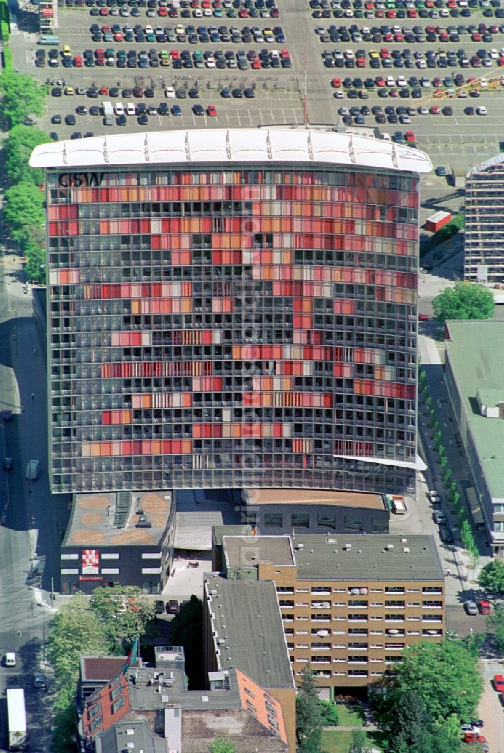 Berlin Kreuzberg from above - The GSW-building was constructed by Sauerbruch Hutton and is the advanced headquarters of the Charitable Settlement and Housing Corporation Berlin. The curved facade from the fourth floor will contribute to reducing energy needs, as well as the second curtain wall on the west side, which is equipped with shutters in various shades of red