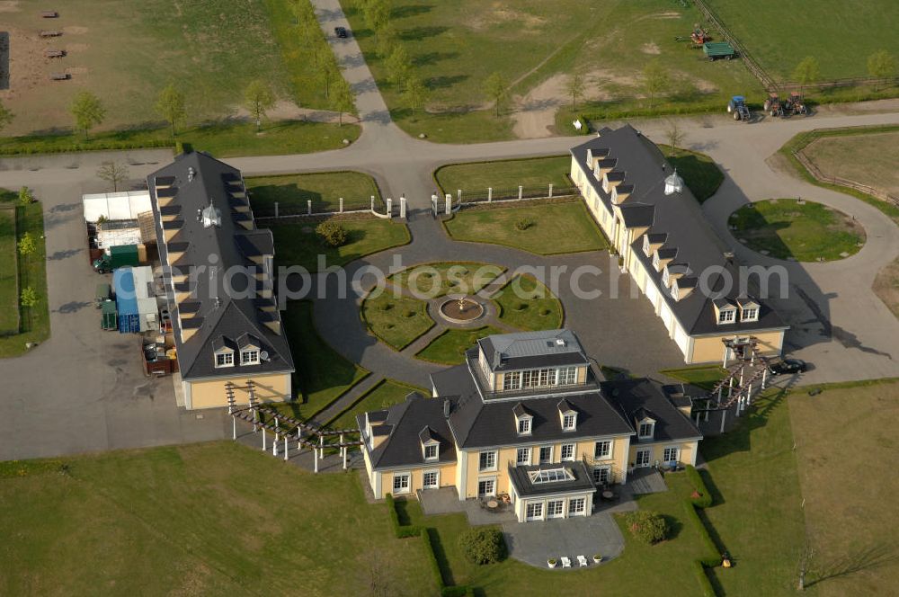 Aerial photograph Lichtenberg - Blick auf das Gut Hersterberg. Das Gut ist als Dreiseitenhof in der Mitte eine 1000 ha großen Grundstücks gebaut worden. Der Schlachterei- und Landwirtschaftsbetrib wurde im jahr 2000 neu gegründet. Gehalten werden Schweine, schafe und Gänse, sowie Pferde nach dem Prinzip der natürlichen Galloway-Haltung. Kontakt: Gut Hesterberg GmbH, Fleisch & Wurstwaren, Gutsallee 1, 16818 Neuruppin-Lichtenberg, Tel. 03391 / 70 06 0, info@gothesterberg.de