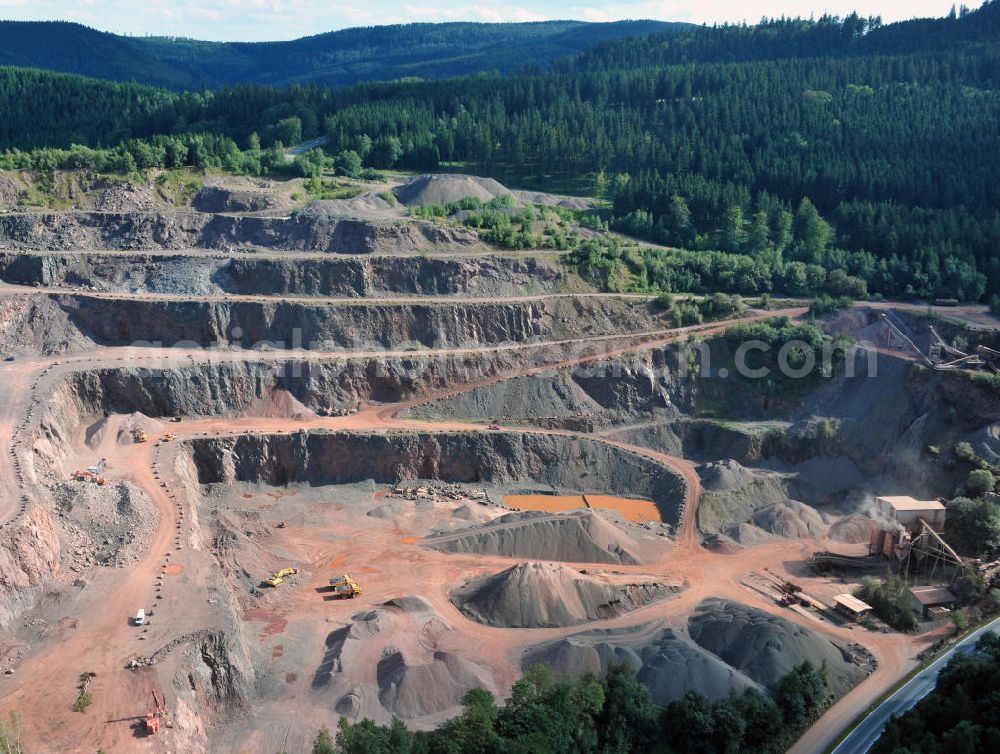 Aerial image Tabarz - Das Hartsteinwerk Tabarz im Thüringer Wald in der Nähe des Ortes Tabarz, Thüringen. Vom Unternehmen MKW Mitteldeutsche Hartstein- Kies und Mischwerke Gmbh werden hier Vulkanite und Sedimentgesteine abgebaut. The stone pit Hartsteinwerk Tabarz in the Thuringian Forest near the place Tabarz, Thuringia. The company MKW Mitteldeutsche Hartstein- Kies und Mischwerke Gmbh mines vulcanic and sedimentary rocks there.