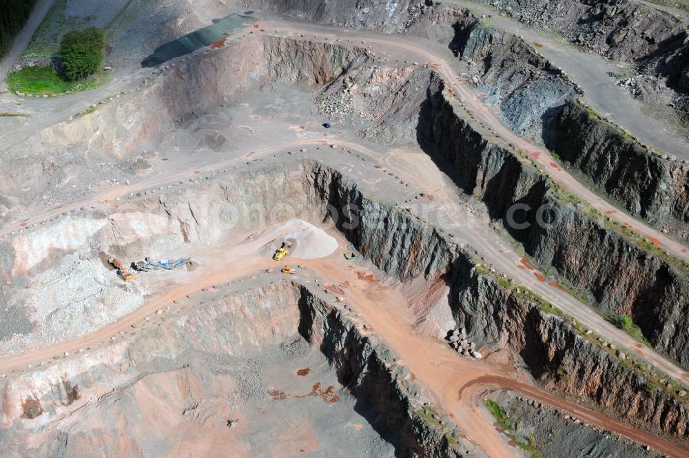 Aerial image Tabarz - Das Hartsteinwerk Tabarz im Thüringer Wald in der Nähe des Ortes Tabarz, Thüringen. Vom Unternehmen MKW Mitteldeutsche Hartstein- Kies und Mischwerke Gmbh werden hier Vulkanite und Sedimentgesteine abgebaut. The stone pit Hartsteinwerk Tabarz in the Thuringian Forest near the place Tabarz, Thuringia. The company MKW Mitteldeutsche Hartstein- Kies und Mischwerke Gmbh mines vulcanic and sedimentary rocks there.