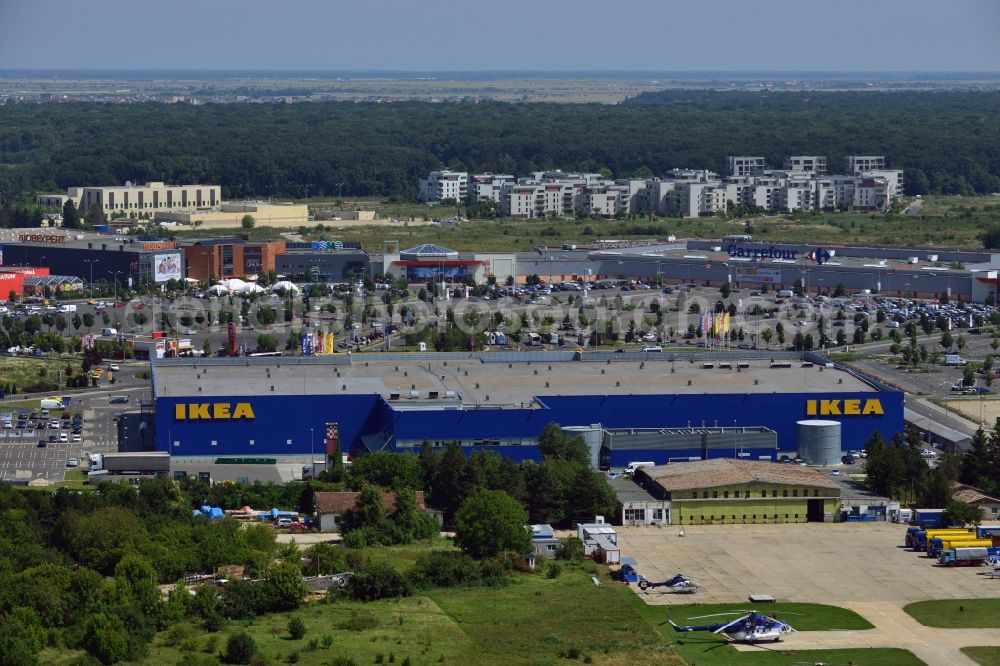 Aerial photograph Bukarest - The IKEA furniture store in the Baneasa Shopping City in the North of Bucharest. The distinct blue building of the Swedish company is located in the North of the Romanian Capital, adjacent to the Baneasa International Airport and within the compound of Baneasa Shopping Center. The yellow building in the background is the embassy of the USA