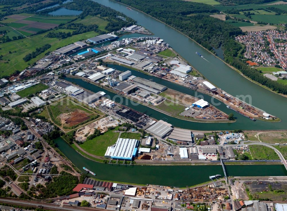 Mannheim from the bird's eye view: The industrial and port area in the Rheinau part of Mannheim in the state of Baden-Württemberg. The facilities are located on the Eastern side of the Rhine. Characterised by the three waterways, it is located opposite the county district of Altrip on the Western side and in the state of Rhineland-Palatinate