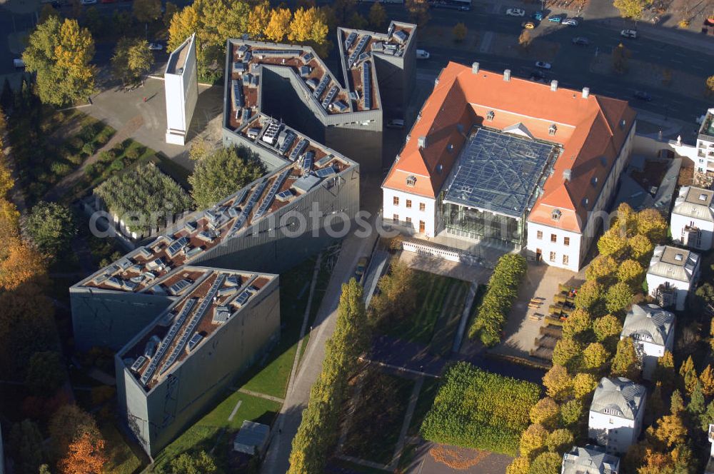 Aerial image Berlin - Das Jüdische Museum Berlin zeigt dem Besucher zwei Jahrtausende deutsch-jüdische Geschichte, die Höhe- und Tiefpunkte der Beziehungen zwischen Juden und Nichtjuden in Deutschland. Das Museum beherbergt eine Dauerausstellung, mehrere Wechselausstellungen, ein umfassendes Archiv, das Rafael Roth Learning Center und Forschungseinrichtungen. All diese Abteilungen dienen dazu, jüdische Kultur und jüdisch-deutsche Geschichte darzustellen.Das Museumsgebäude in der Kreuzberger Lindenstraße verbindet den barocken Altbau des Collegienhauses (ehemaliger Sitz des Kammergerichts) mit einem Neubau. Der zickzackförmige Bau geht auf einen Entwurf des amerikanischen Architekten Daniel Libeskind zurück. Die im Freien fortgesetzte Form erinnert auch an einen geborstenen Davidstern.Das Museum ist eine Stiftung öffentlichen Rechts in der Verantwortung des Bundes unter der Direktion von W. Michael Blumenthal. Es hatte 2005 rund 690.000 Besucher und gehört damit zu den meistbesuchten Museen Berlins.