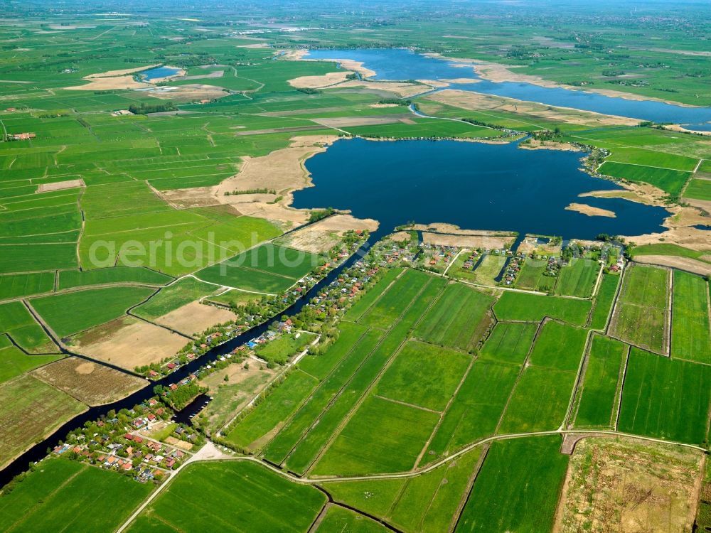 Hinte from the bird's eye view: The lake Kleines Meer - small sea - in the borough of Hinte in the state of Lower Saxony. The lake is also called Hieve. Located in the background is a bigger lake, the big sea. A channel - das Kurze Tief - connects the lake with a river and the ocean. The area is a beloved recreational site