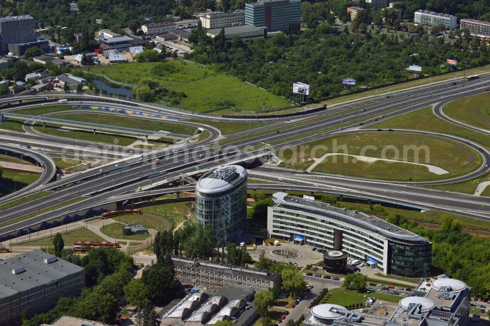 Aerial photograph Warschau - The junction of the Expressway S79 in the Sluzewiec part of the district of Mokotow in Warsaw in Poland. The Droga ekspresowa S79 is a spur route running from North to the South towards the southern Warsaw motorway ring. The part adjacent to the Sasanki Street was completed in 2013. This part connects the Chopin Airport to the Expressway and Motorway network. The distinct round building is an office building of the BNP Paribas Bank in the office quarters of Trinity Park II