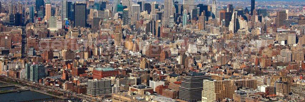 Aerial image New York - View of the shore of New York's Midtown West shore in the district of Manhattan with the boroughs of Chelsea and the skyline of Garment in the background. On the shore are the piers of the Hudson River park with sports field of Pier 40