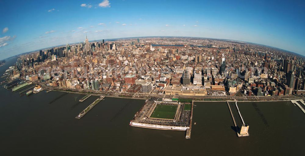 Aerial photograph New York - Fish-eye view of the shore of New York's Midtown West shore in the district of Manhattan with the boroughs of Chelsea and the skyline of Garment in the background. On the shore are the piers of the Hudson River park with sports field of Pier 40