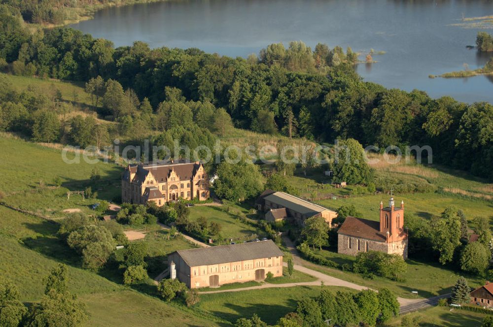 Aerial photograph Tornow - Blick auf das Schloss Tornow. Erbaut wurde das Schloss zwischen 1888 und 1898 durch Friedrich Wilhelm IV. im Stil der Backsteingotik. 1993 zog das Ökowerk in das Gebäude und richtete eine Wolfgang Gerbere Bildungsstätte. Themen sind Umweltbildung und Klimaschutz, Aufklärungs- und Bewustseinsarbeit für die Gesellschaft. Zusätzlich wurden im Schloss Übernachtungsmöglichkeiten eingerichtet. Kontakt: Ökowerk Brdg. e.V., Lothar Semsch, Schloss Tornow, 16798 Fürstenberg / Havel OT Tornow, Tel. 0172 / 687 38 29 oder 030 / 832 25 619,